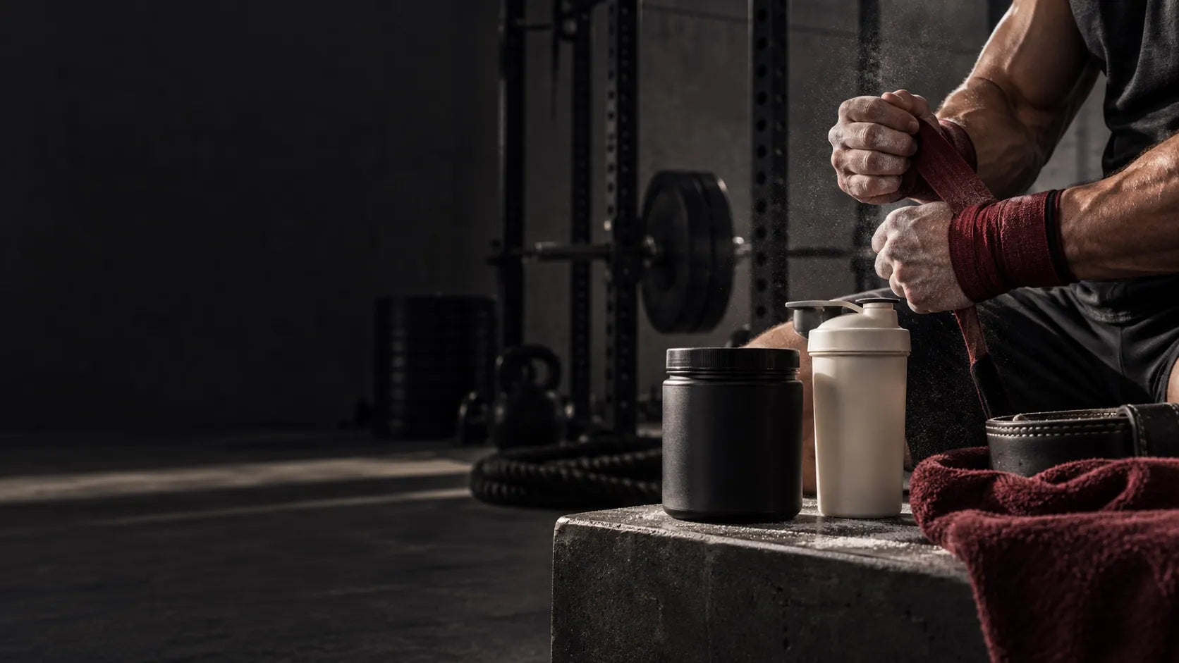 Athlete wrapping their wrists beside supplement containers
